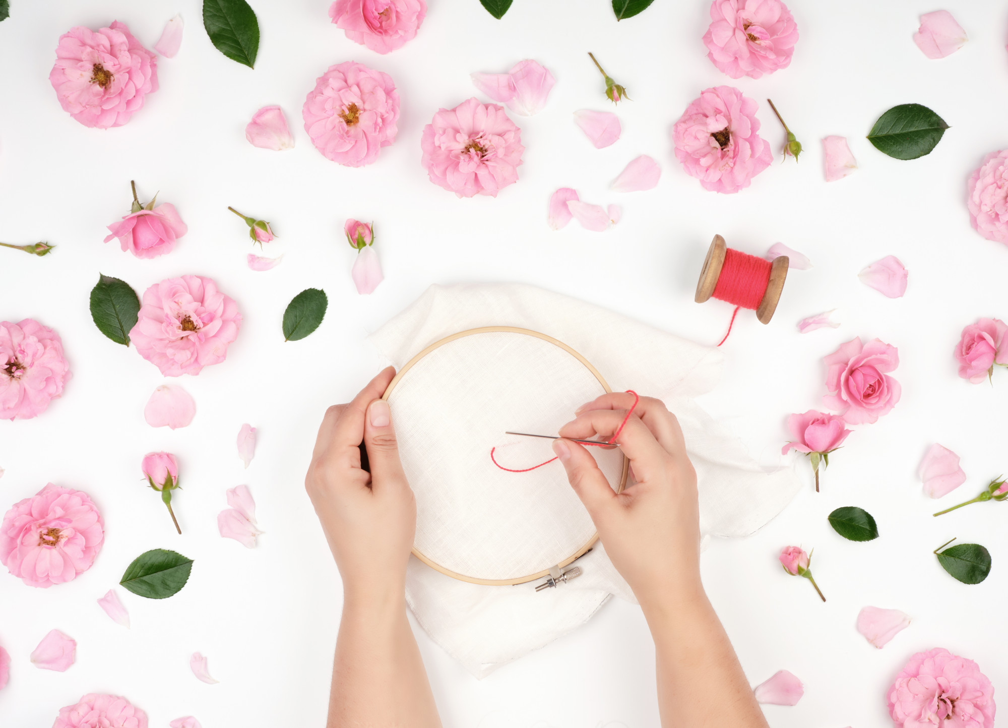Student stitching floral motif